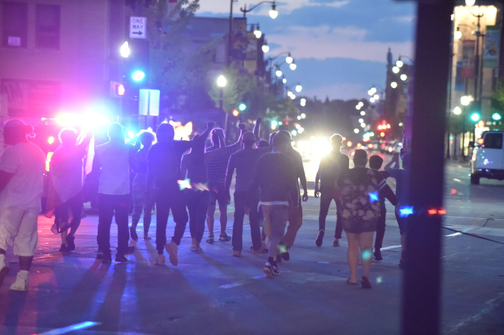 Marching down Main Street while squad car lights flash